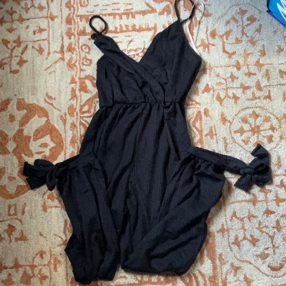 Black womenswear jumpsuit with bottom ties